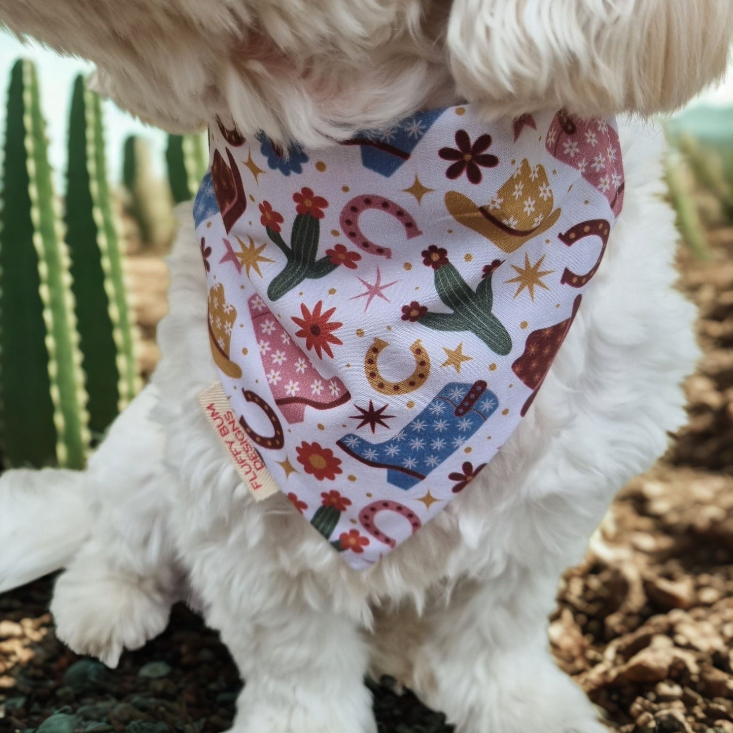 Small White Dog wearing western themed bandana - close up of bandana
